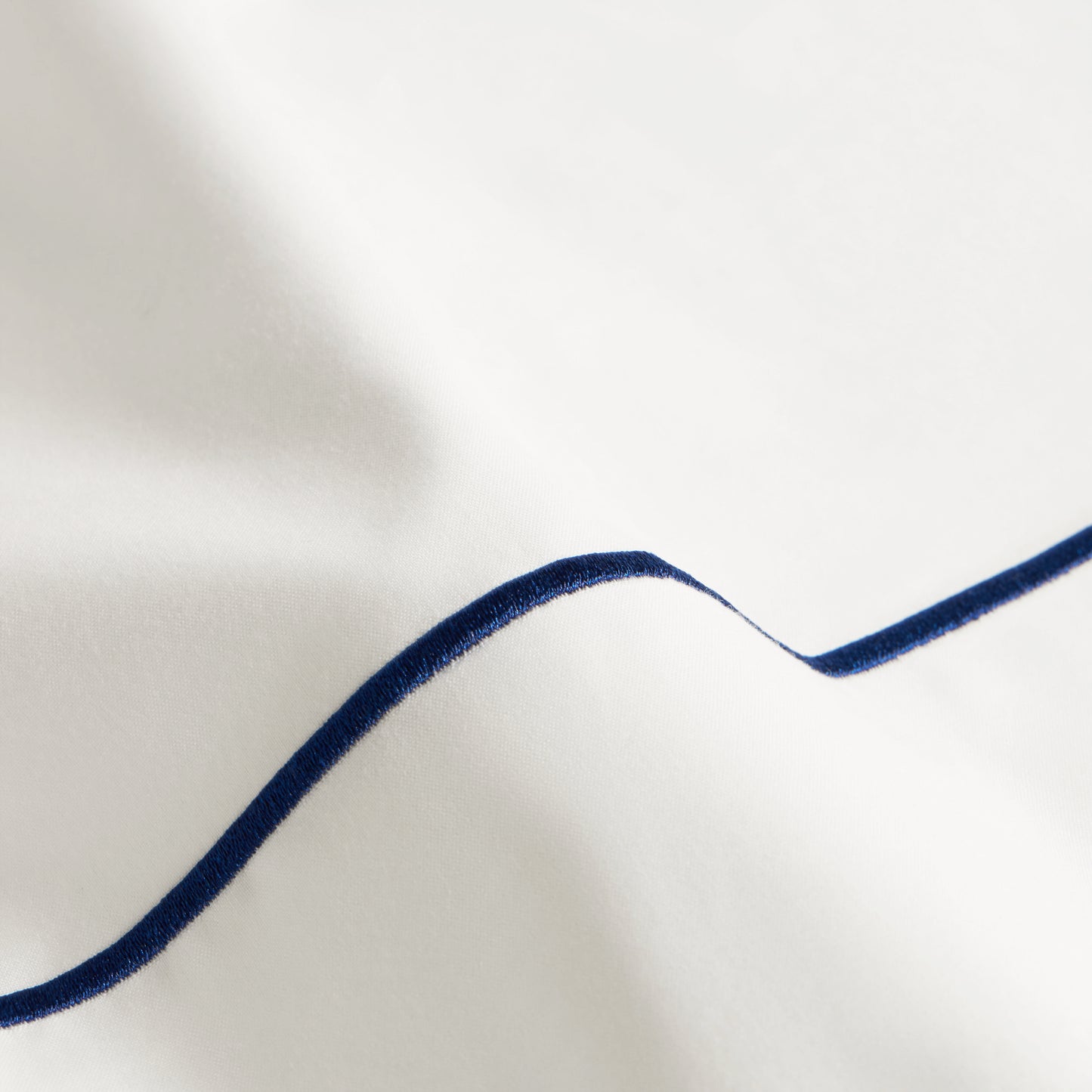 SlumberEmbroideredStripePercaleSheetSet_NavyWhite_Home_StillLife_1x1_0084.jpg