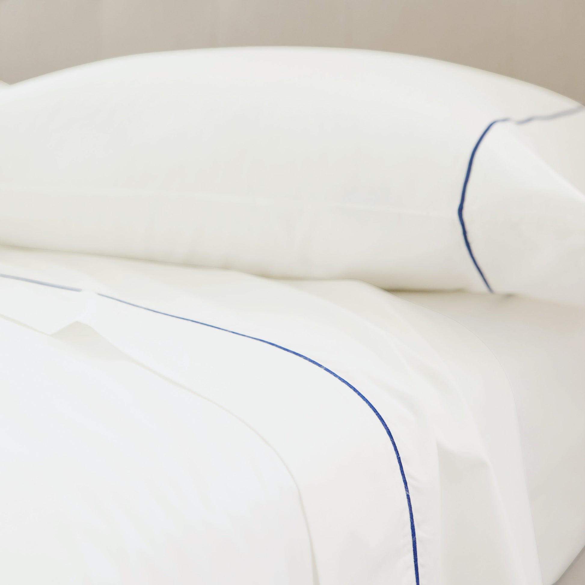 SlumberEmbroideredStripePercaleSheetSet_NavyWhite_Home_Lifestyle_3x4_Crop.jpg